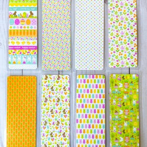 May include: Eight colorful Easter-themed bookmarks with various patterns. The patterns include carrots, bunnies, Easter eggs, flowers, and polka dots.