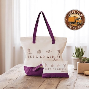 a white and purple bag sitting on top of a wooden table