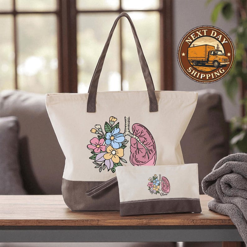 a white tote bag with a floral design and a smaller bag with a similar floral design, both placed on a wooden surface.