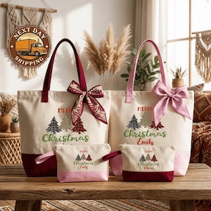 a set of four Christmas-themed tote bags and a small pouch, all with the text "Merry Christmas Emily" printed on them. The bags are arranged on a wooden surface, with a window and some plants visible in the background.