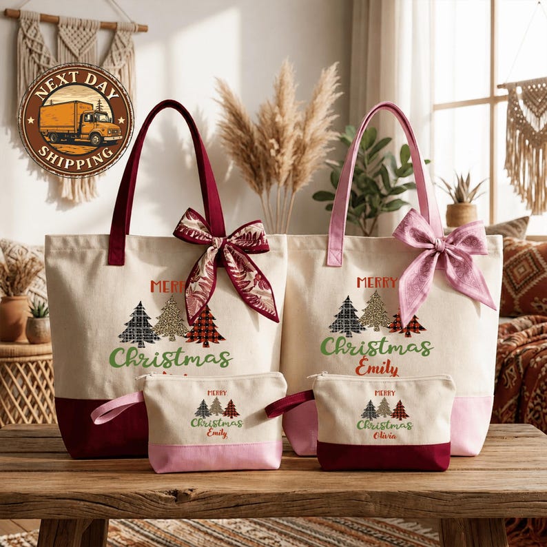 a set of four Christmas-themed tote bags and a small pouch, all with the text "Merry Christmas Emily" printed on them. The bags are arranged on a wooden surface, with a window and some plants visible in the background.