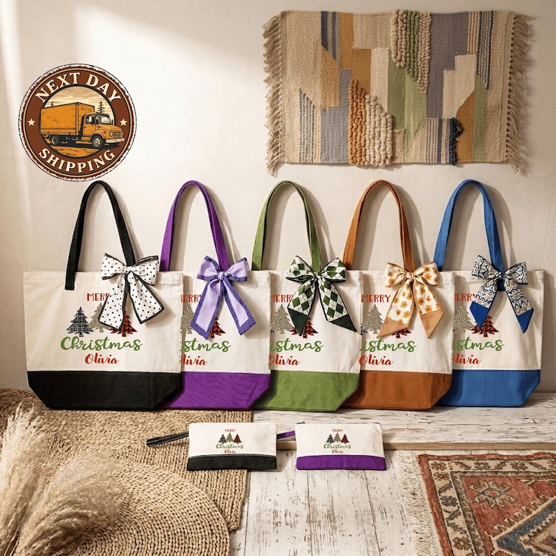 A collection of colorful tote bags with Christmas tree designs, each with a personalized name printed on them, displayed on a wooden floor against a wall with a rug.