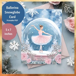 May include: A 12.7 x 17.8 cm printable PDF card depicting a ballerina within a snow globe. The ballerina is in a pink tutu, dancing on a stage with winter decorations. The card has a blue and white winter theme with the text "Ballerina Snowglobe Card".