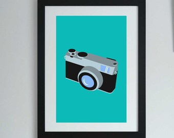 May include: A framed print of a vintage camera on a turquoise background. The camera is black with a silver lens and a silver top.