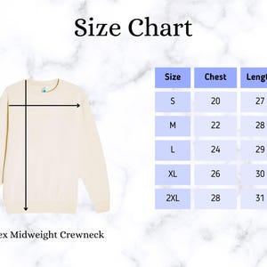 May include: Cream-colored unisex midweight crewneck sweatshirt with a size chart. The chart shows chest and length measurements for sizes S to 2XL. The size chart is in inches.