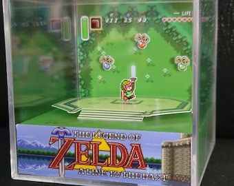 May include: A clear acrylic display case with a miniature diorama of the video game "The Legend of Zelda: A Link to the Past". The diorama features Link, the main character, standing on a platform with a sword in hand. There are also several items scattered around the platform, including hearts, rupees, and a green potion.