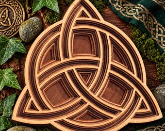 May include: A multi-layered wooden wall art piece featuring a triquetra knot design. The object is constructed from stacked layers of light and dark wood, creating a deep, dimensional effect with intricate, interlocking geometric curves.