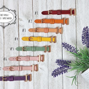 May include: Eight leather watch straps in a range of colours, such as red, orange, yellow, green, pink, and purple. Each strap features a gold-coloured buckle and is designed for Fitbit Versa, Sense, and Apple Watch.