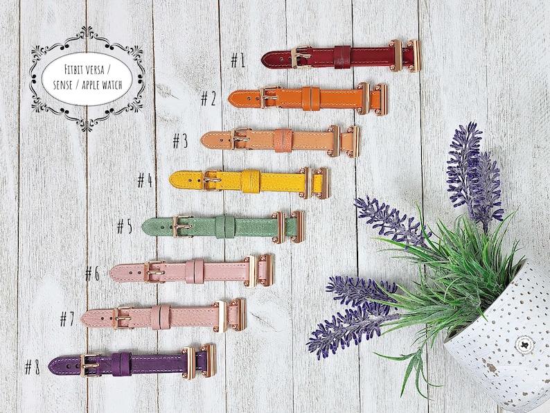 May include: Eight leather watch straps in a range of colours, such as red, orange, yellow, green, pink, and purple. Each strap features a gold-coloured buckle and is designed for Fitbit Versa, Sense, and Apple Watch.