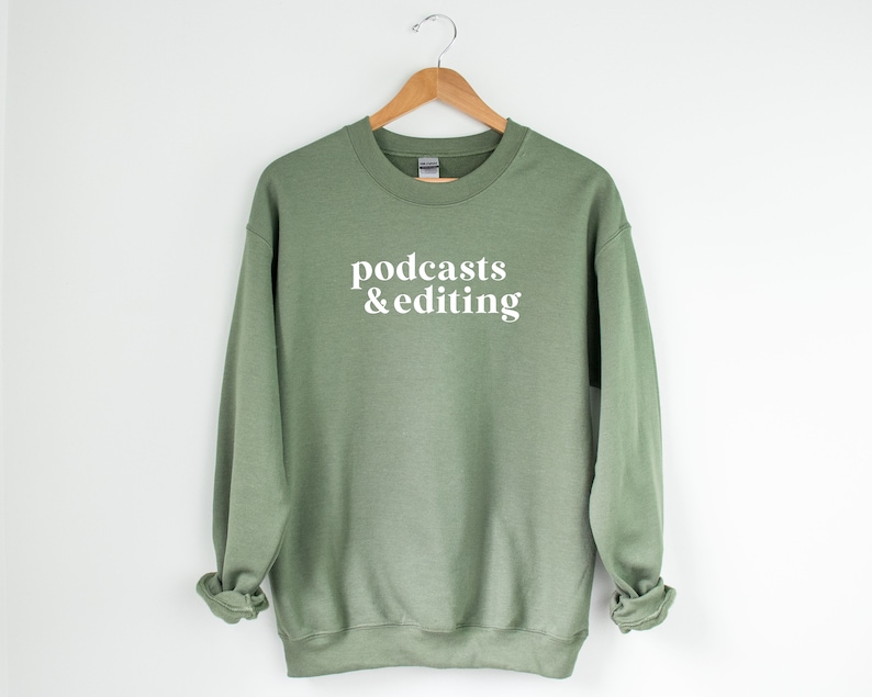 K&ouml;nnte beinhalten: Ein salbeigr&uuml;ner Pullover mit dem Text "podcasts & editing" in Wei&szlig;.