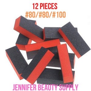 May include: A collection of twelve rectangular nail buffer blocks. Each block is black on two sides and red on the other two sides. The text "12 PIECES #80/#80/#100" is printed in red and orange. The text "JENNIFER BEAUTY SUPPLY" is printed in pink.