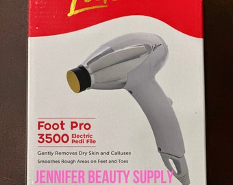 May include: A gray and silver Latina Foot Pro 3500 electric pedi file. The box has red and white sections with gold lettering. The text on the box says it gently removes dry skin and calluses and smoothes rough areas on feet and toes.