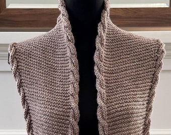 May include: A brown and beige knitted scarf with a braided design. The scarf is displayed on a mannequin.