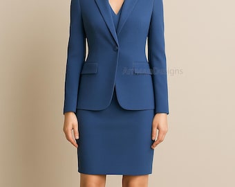 May include: A blue business suit consisting of a blazer and a skirt. The blazer has a single-button closure and two front pockets. The skirt is knee-length. The suit is a solid color and appears to be made of a smooth fabric. The text "Amaan Designs" is visible.
