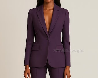 May include: A plum-colored blazer and matching pants suit. The blazer has a notched lapel, a single-button closure, and two front pockets. The suit is tailored and appears to be made of a smooth fabric. The text "ArmaanDesigns" is visible on the lower right.