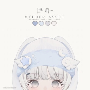 May include: A digital VTuber asset featuring a light blue headband with white wings, a blue star, and a silver crescent moon charm. The text reads Little Moon VTUBER ASSET Compatible with Vtube Studio, with four heart icons in shades of blue and white.