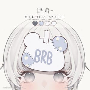 May include: A digital graphic asset for a VTuber model featuring a white bear-shaped sign with the text BRB in light blue. The sign has light blue floral patches on the ears and is attached with a white tape graphic. The text Little Moon VTUBER ASSET is visible.