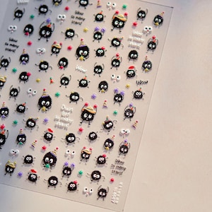 May include: Clear sheet of nail art stickers featuring cartoon soot sprites with various hats and accessories. The stickers include the text "Wow so many stars!" and "Dust off so many stars!"