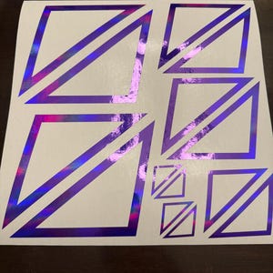 May include: A sheet of white vinyl with multiple purple holographic diamond shapes. The diamonds are outlined in a darker purple.