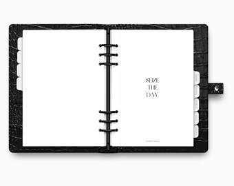 May include: Open black leather planner with white pages and dividers. The planner is open to a page with the words "SEIZE THE DAY" printed in black. The planner has a snap closure.