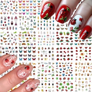 May include: A collection of nail art stickers featuring various insects, butterflies, and floral designs. The image also shows manicured nails with ladybug and floral nail art. The stickers come in a variety of colors and sizes.