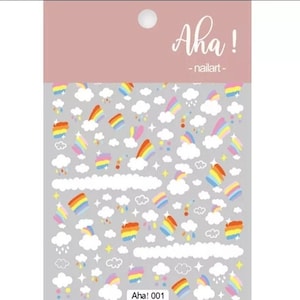 May include: A sheet of rainbow and cloud nail art stickers. The sheet is filled with colourful rainbows, white clouds, and small stars and raindrops. The text "Aha! 001" is printed at the bottom of the sheet.