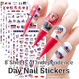 May include: Eight sheets of Independence Day nail stickers featuring red, white and blue American flag designs, hearts, stars and the words "I Love USA".