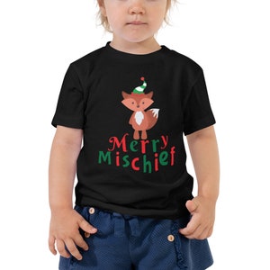 May include: Black toddler t-shirt with a red fox wearing a green and red elf hat. The text "Merry Mischief" is printed in red and green on the shirt.