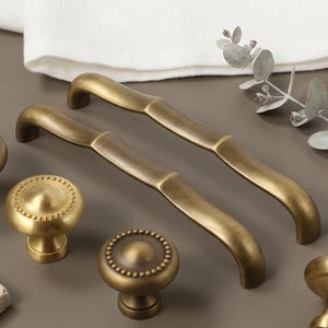 May include: A handmade wooden sign with the text "Welcome to our home" in a handwritten style. The sign is painted white with black lettering and a distressed finish, suitable for indoor or outdoor use.