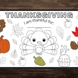 May include: A black and white printable Thanksgiving coloring page featuring a turkey, pumpkin, leaves, and a pie. The page includes the text "THANKSGIVING" and "I am thankful for:"