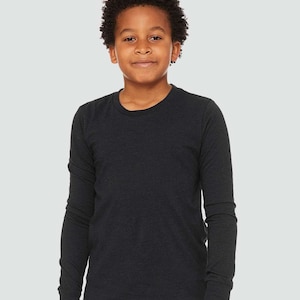 May include: A black long-sleeved t-shirt for kids. The shirt is made of a soft, comfortable fabric and has a relaxed fit.