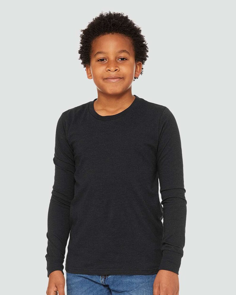 May include: A black long-sleeved t-shirt for kids. The shirt is made of a soft, comfortable fabric and has a relaxed fit.