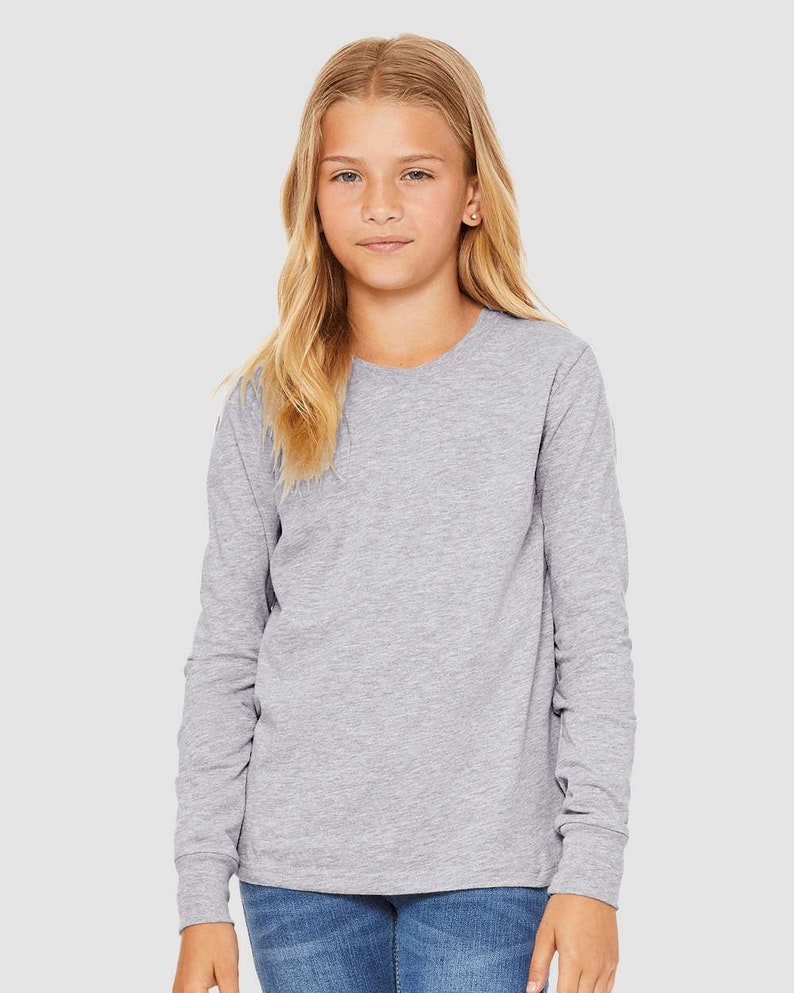 May include: A heather gray long-sleeve t-shirt for kids. The shirt has a crew neck and is made of a soft, comfortable fabric.