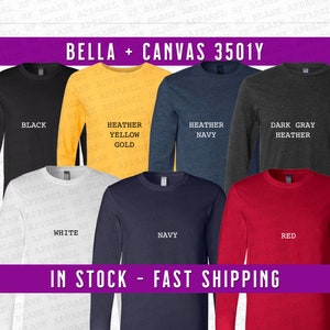 May include: A variety of long-sleeve shirts in different colors, including black, white, heather yellow gold, heather navy, dark gray heather, and red. The shirts are all Bella + Canvas 3501Y. The text "IN STOCK - FAST SHIPPING" is at the bottom of the image.