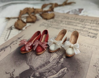 May include: Four miniature doll shoes with bows. Two are red and two are white.