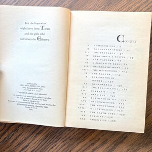 The image displays the opening pages of the book "The High King" featuring a dedication and a table of contents. The dedication reads, "For the boys who might have been Taran and the girls who will always be Gilonwy."