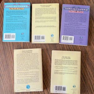 This image shows the back covers of five paperback books by Lloyd Alexander, all part of his Prydain Chronicles series. The texts contains a synopsis of each book, and excerpts from reviews. At the bottom, barcodes and ISBNs are visible.