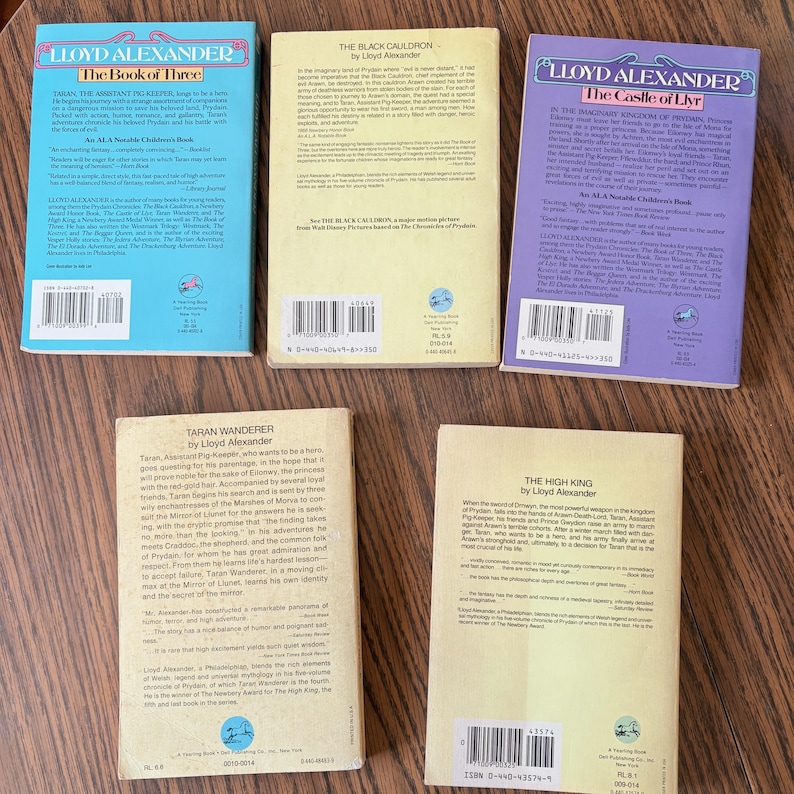 This image shows the back covers of five paperback books by Lloyd Alexander, all part of his Prydain Chronicles series. The texts contains a synopsis of each book, and excerpts from reviews. At the bottom, barcodes and ISBNs are visible.