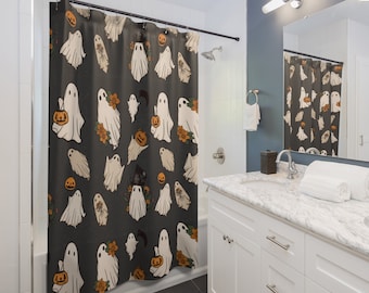 May include: A black shower curtain with a white ghost and pumpkin pattern. The ghosts are holding pumpkins and there are flowers and moons in the background.