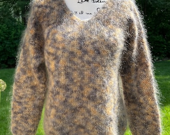 May include: A fuzzy, gray and yellow sweater with a v-neck.