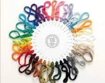 May include: A variety of 24 skeins of yarn in different colors, arranged in a circle. The yarn is made of natural fibers and is perfect for knitting or crocheting.