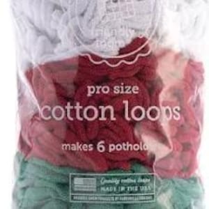 May include: A clear plastic bag filled with white, red, and green cotton loops. The bag has the words "pro size cotton loops" and "makes 6 potholds" printed on it. The product is labeled "Ages 8+".