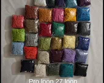 May include: A collection of twenty-seven individual square plastic bags, each containing a different colored loop of fabric. The text Pro loop 27 loop color packs is printed at the bottom of the image. The colors include white, black, purple, teal, red, brown, orange, pink, yellow, blue, green, gray, and beige.