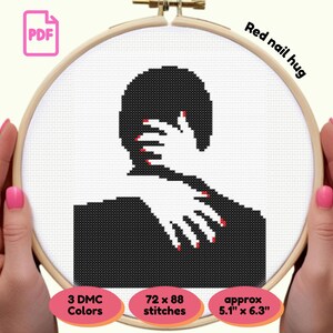 May include: Cross-stitch pattern of a hug, featuring a black silhouette embracing another. The hands have red nail polish. The text "Red nail hug" is visible. The pattern is approximately 5.1" x 6.3" and uses 3 DMC colors.
