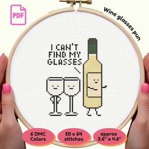 May include: A cross-stitch design in a wooden hoop with the text "I can't find my glasses" above a cartoon wine bottle and two glasses. The design is approximately 3.6" x 4.6" and uses 6 DMC colors. The words "Wine glasses pun" are written on the top.