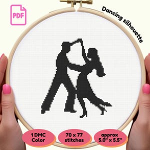May include: A cross-stitch pattern of a dancing couple in black silhouette, held in a wooden embroidery hoop. The text "Dancing silhouette" is above the design. The pattern is approximately 5.0" x 5.5" and uses 1 DMC color.