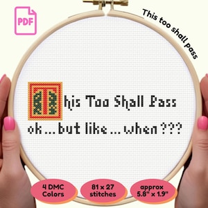May include: Cross-stitch embroidery in a wooden hoop with the text "This too shall pass" and "ok... but like... when???". The design includes a decorative initial "T". The finished piece is approximately 5.8 inches by 1.9 inches.
