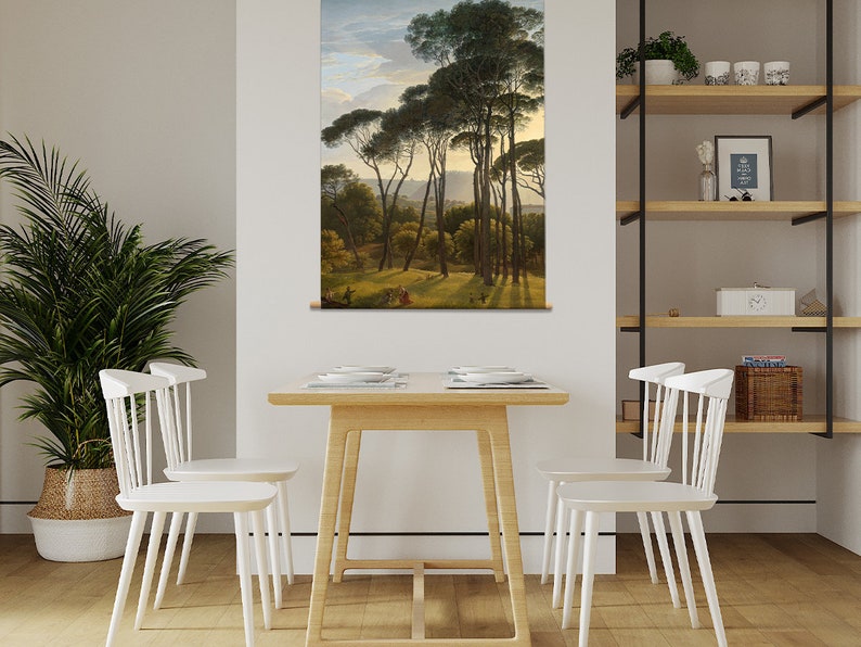 May include: A painting of a forest scene with tall pine trees and a path leading through the trees. The painting is framed and hanging on a wall in a room with a wooden table and white chairs.