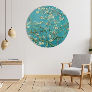 May include: A round wall art print featuring a painting of a blooming almond tree with white flowers against a blue sky. The painting is in a circular frame.