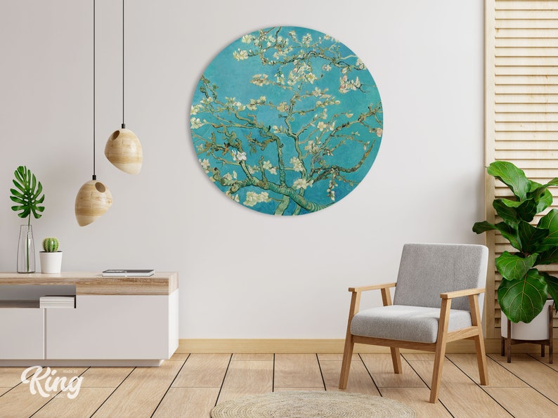 May include: A round wall art print featuring a painting of a blooming almond tree with white flowers against a blue sky. The painting is in a circular frame.